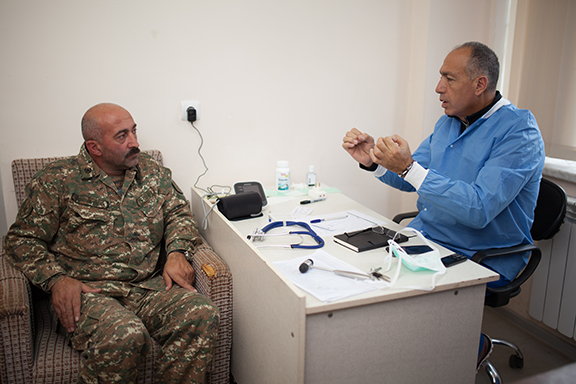 Internal medicine Dr. Manvel Mazmanyan reviewing a patient during a check up and explaining chronic health problems.