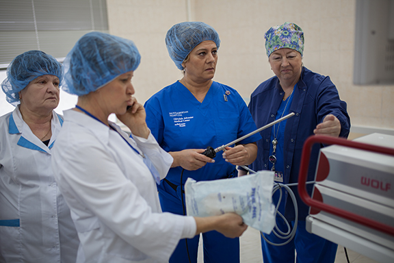 GAMC Director of Perioperative Services Suzanne Axt (far right) and Juliet Khodadadi review and prepare laparascopic equipment ahead of surgery.