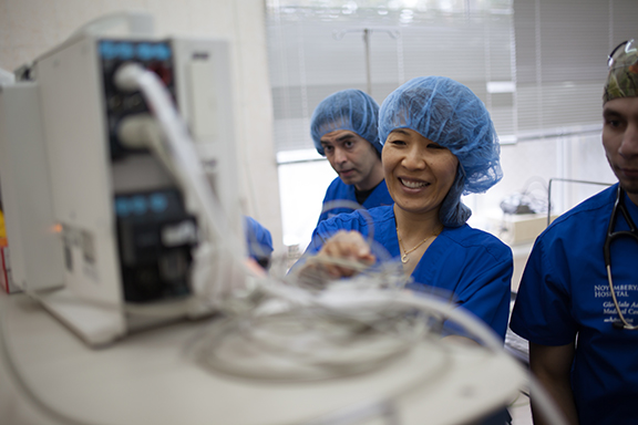 Anesthesiologist Dr. Robin Kim and biomedical engineer Armen Manookian (left) prepare the newly arrived anesthesia machines in the operating room.