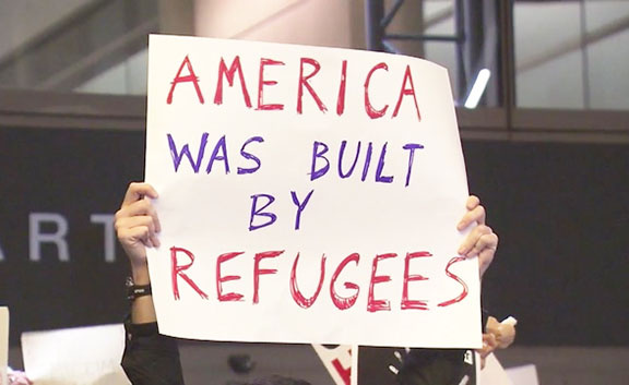 A placard displayed by a protester at LAX, one of many such actions that took place across US airports over the weekend