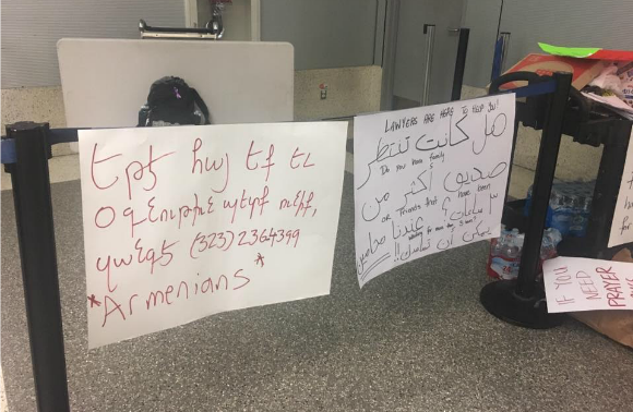 Signs at Los Angeles International Airport offering translation help for newcomer immigrants.